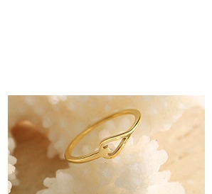 Macro shot of 18K gold plated snake chain necklace with heart pendant on white stone