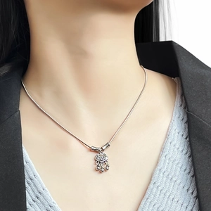 Detail of silver longevity lock pendant with mini bells on a delicate snake chain