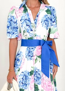 Detail of floral bohemian dress with blue and pink hydrangeas and a satin belt