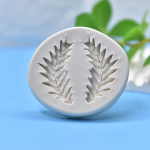 White silicone leaf mold for soap and fondant DIY on a vibrant blue background