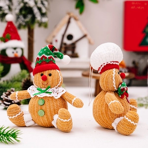 Detail of knitted gingerbread man plush toys with festive hats and textured yarn fabric
