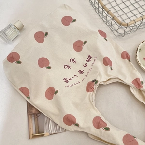 Detail of peach print canvas tote bag with Japanese text and sweet peach graphics