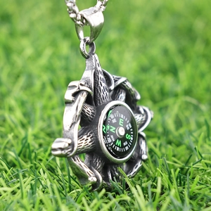 Nautical compass pendant necklace in antique silver finish for men on green grass