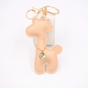 Detail of pink PU leather giraffe keychain with golden hardware and Super engraving