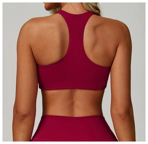 Detail of burgundy racerback sports bra showing ergonomic fit and high-elastic matte fabric