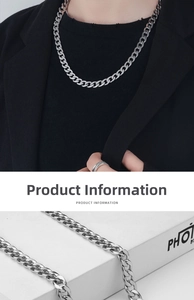 Close-up of silver Cuban link chain and textured ring on a clean white display
