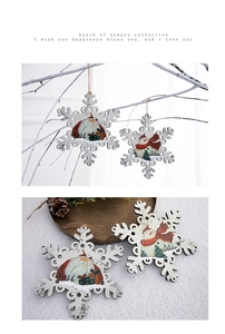 Macro detail of white wooden snowflake ornaments with hand-painted Santa and snowman