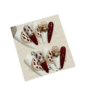 Handmade stiletto press-on nails with burgundy leopard print and star rhinestone