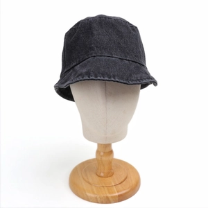 Close-up of black denim bucket hat with detailed stitching on wide brim surface