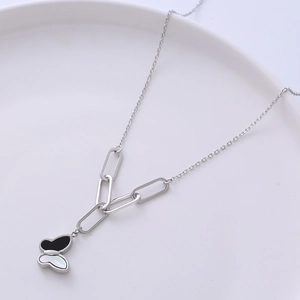Silver butterfly necklace with black and white shell pendant on a refined chain