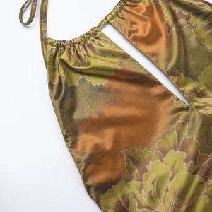 Detail view of gathered halter neckline on floral satin dress with olive green tones