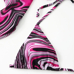 Close-up of pink and black marble stripe bikini top and mesh cover-up set details
