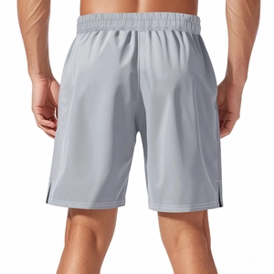 Rear view of grey quick-dry sports shorts showing elastic waistband on male model