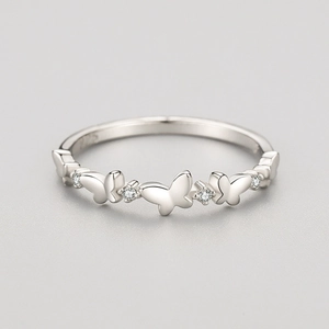 S925 sterling silver butterfly ring with micro-pave cubic zirconia on a gray surface