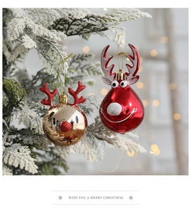 Close-up of red and gold reindeer Christmas tree ornaments with festive bokeh lighting