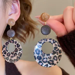 Retro acrylic leopard print round dangle earrings with wood accents and silver needle post