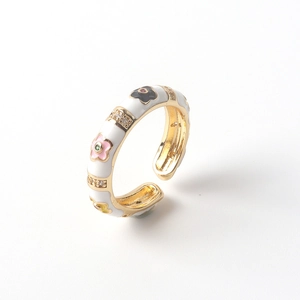 Macro detail of 18K gold plated ring featuring colorful enamel flowers and zircons