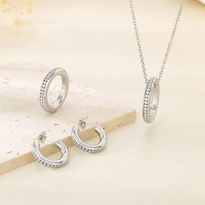 Detailed set of silver steel necklace, earrings and ring with pavé cubic zirconia