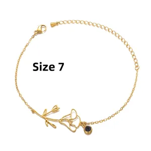 Detail of gold flower bracelet with purple gemstone charm and adjustable clasp
