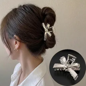 Detailed view of a silver liquid metal butterfly hair claw clip for elegant hairstyles