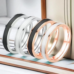 Detail of minimalist stainless steel rings in silver and rose gold with ceramic inlay