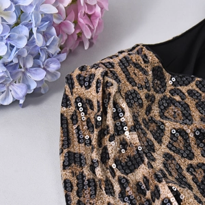 Close-up of leopard print fabric with black sequins on a long sleeve blazer jacket
