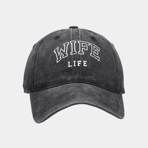 Close-up of WIFE LIFE white embroidery on a washed dark gray vintage baseball cap