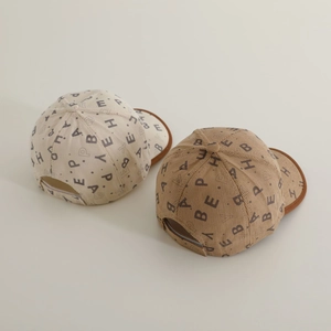 Detail of corduroy baseball cap with letter prints and brown brim contrast