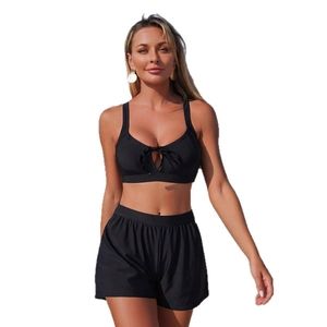 Two-piece black sporty bikini set with teardrop cutout and high-waisted swim shorts