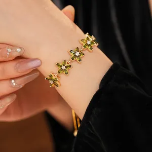 Adjustable gold star flower bracelet with green marquise cubic zirconia stones
