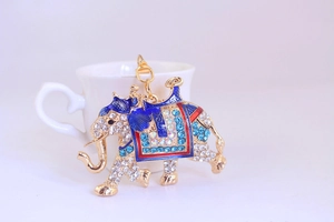 Close-up of golden elephant keychain featuring colorful enamel and sparkling rhinestones