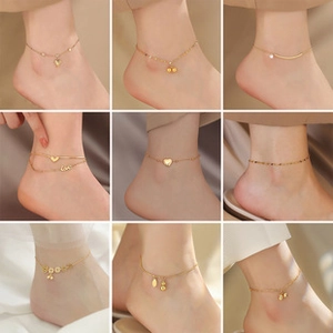 Cuadrícula de tobilleras de acero de titanio dorado con dijes de corazón y cuentas