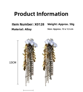 Detail view of 13cm long gold tassel earrings with cubic zirconia and leaf accents