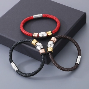 Detailed view of woven leather bracelets in red, black, and brown with magnetic metal clasps