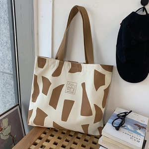 Canvas tote bag for students featuring retro abstract patterns and sturdy brown handles