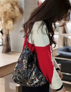 Close-up of vintage Chinese style embroidered shoulder bag with floral jacquard texture