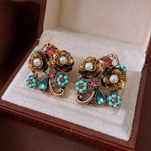Vintage flower earrings with pearls and crystals in a premium brown leather jewelry box