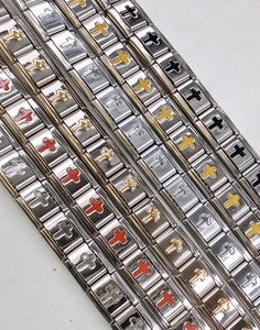 Close-up of stainless steel Italian charm bracelets with colorful cross-pattern links