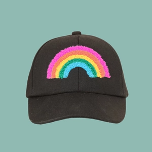 Detail of colorful toweling embroidery rainbow on a black cotton baseball cap for kids