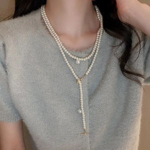 Close-up of layered French vintage pearl necklace with OT toggle clasp and large pendant