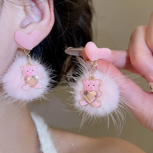 Detailed view of pink plush bear earring with heart flocking and fuzzy pompom detail