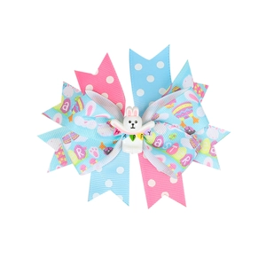 Detail of multi-layered Easter bow hair clip with bunny and colorful polka dot ribbons