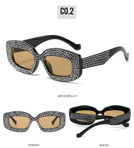 Three-view display of black cat-eye sunglasses with rhinestone frames and amber lenses