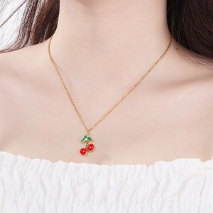 Fashion minimalist stainless steel necklace with red cherry pendant worn by a model
