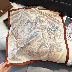 Detailed close-up of a printed silk square scarf with vintage carriage and star patterns