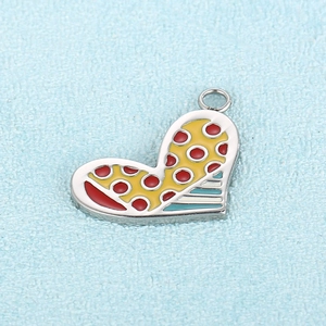 Detailed close-up of colorful enamel heart pendants in red, yellow, and blue with silver rings