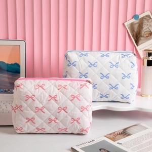 Quilted bow makeup bag set in pink and blue floral designs for travel storage