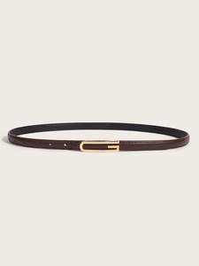 Close-up of a dark brown leather belt with a rectangular gold buckle on beige background