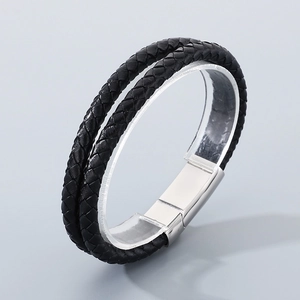 Close-up of black braided double-layer leather bracelet with silver magnetic clasp
