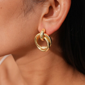 Close-up of elegant double gold hoop earrings on model featuring a minimalist nested design